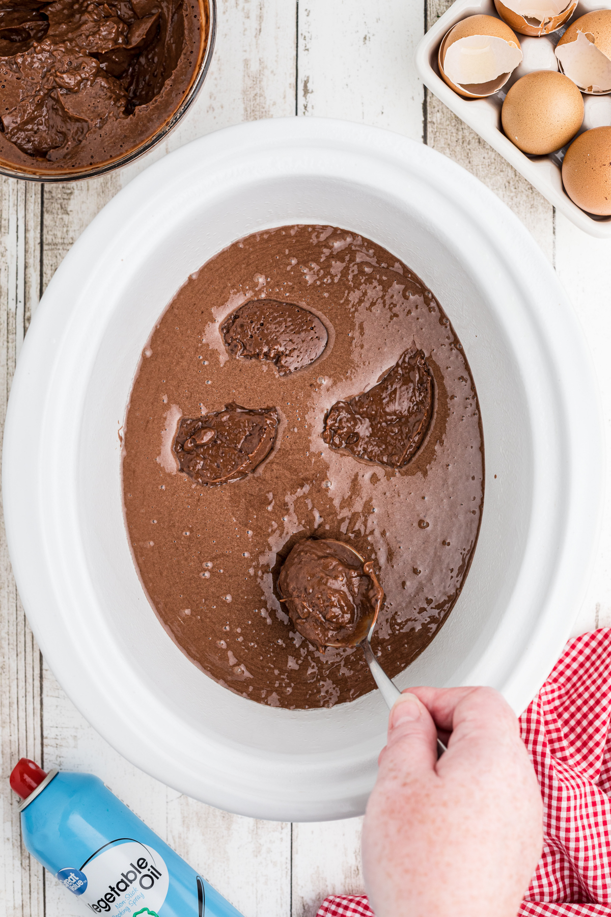 chocolate cake mix batter with pudding mix dollops on it.