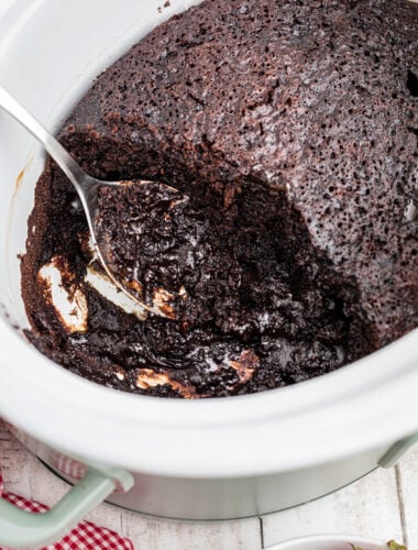 lava cake in a slow cooker with a metal spoon in it.