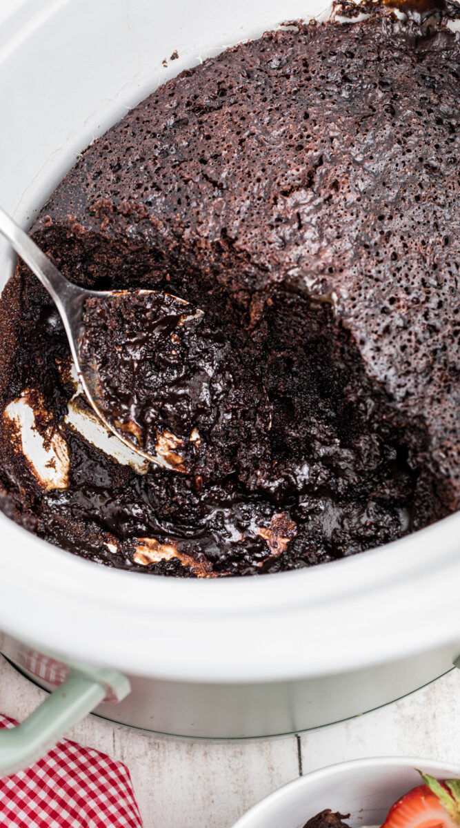 lave cake cooked in a slow cooker with a spoon in it.