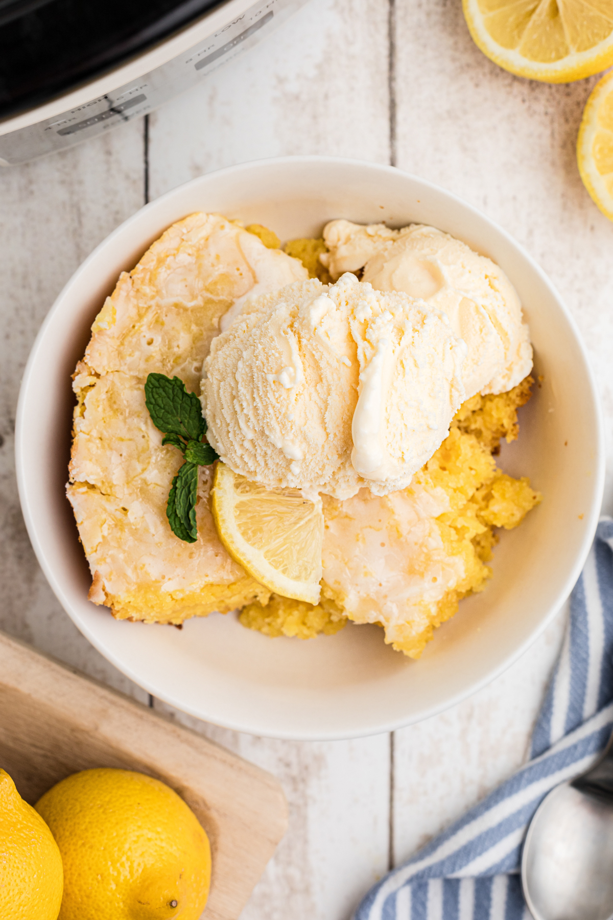 crockpot lemon cake with ice cream on top.