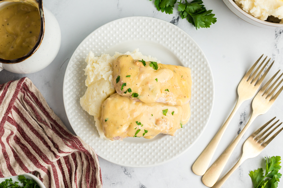 overhead shot of creamy ranch pork chops on a plate.