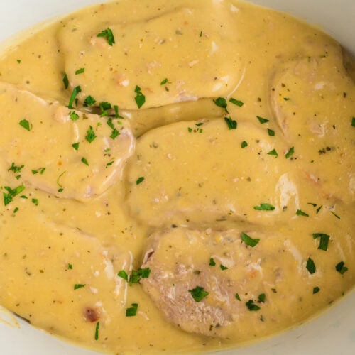 pork chops in a slow cooker in a creamy ranch sauce.