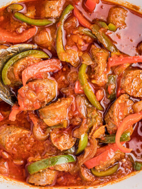 overhead shot of sausage and peppers in a slow cooker.