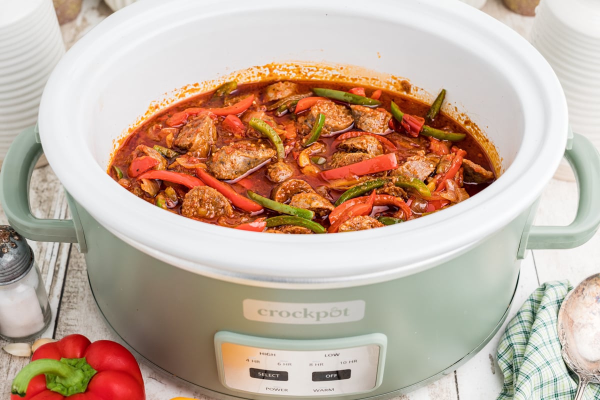 sausage and bell peppers in a crockpot, done cooking.