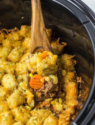 shepherd's pie in a slow cooker with a spoon in it.