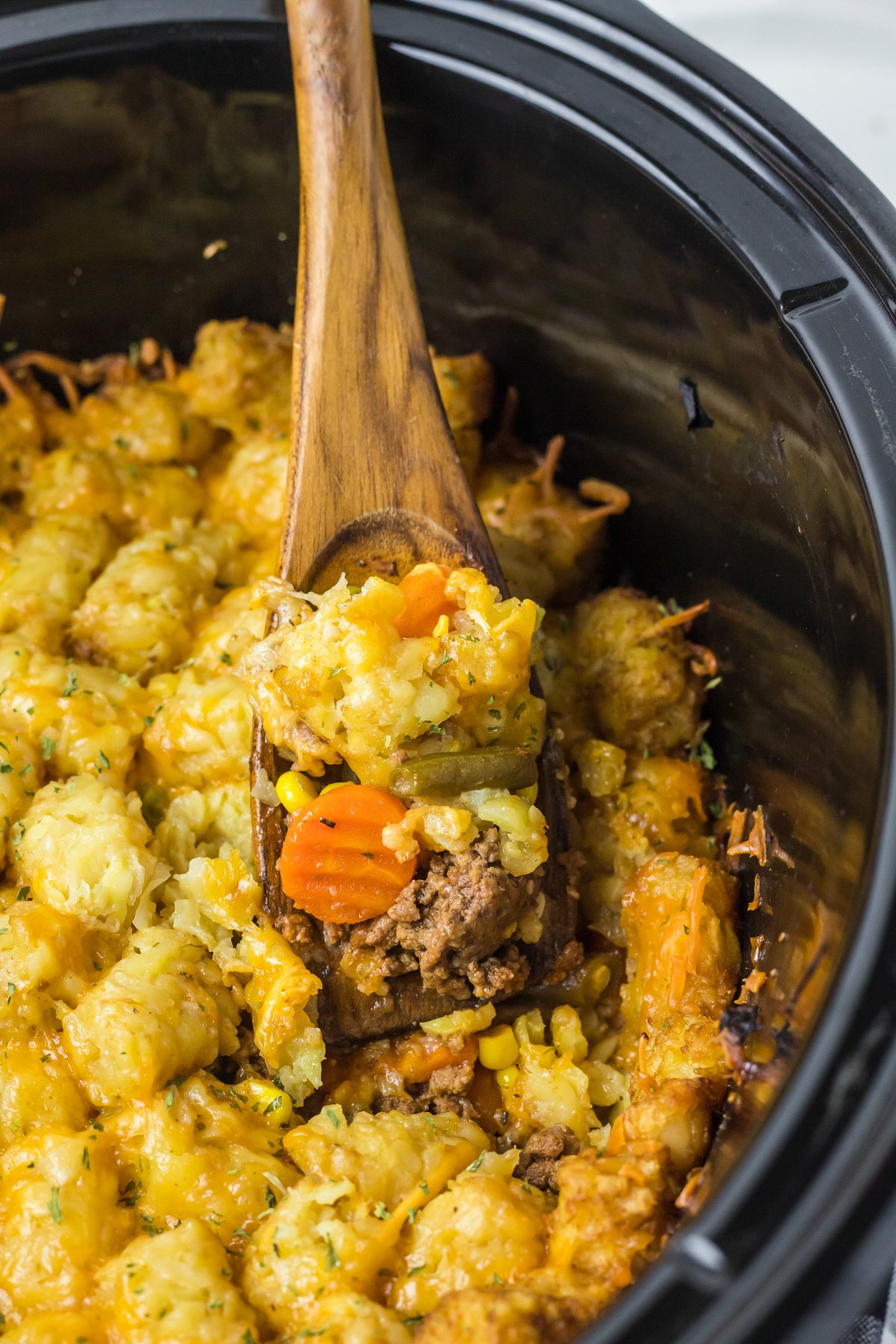 shepherd's pie in a slow cooker with a spoon in it.