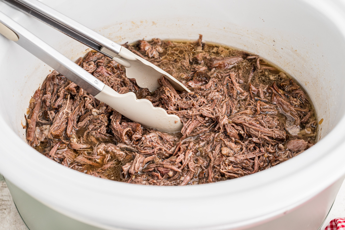 Shredded beef for sandwiches in a slow cooker.