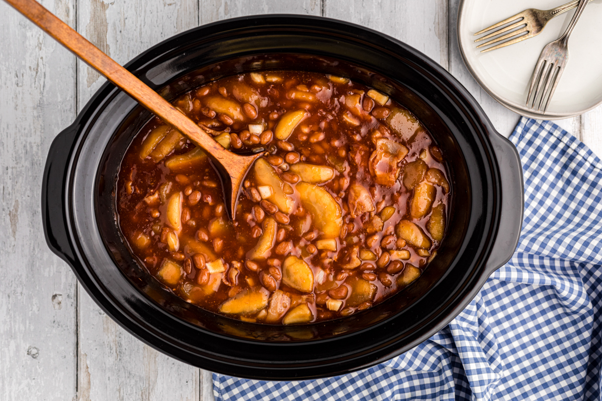 Apple pie filling and baked beans in a crockpot.