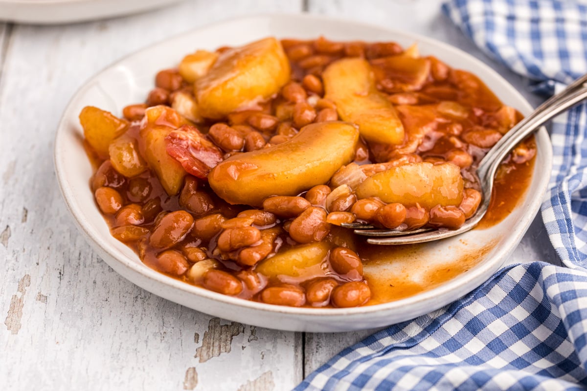 Plate of baked beans with fork in it.