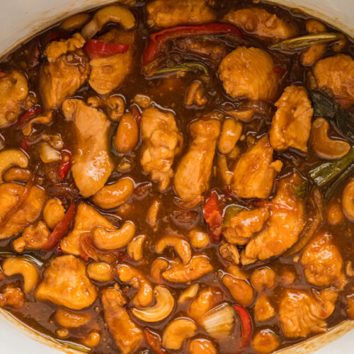 close up of cashew chicken, done cooking in a slow cooker.