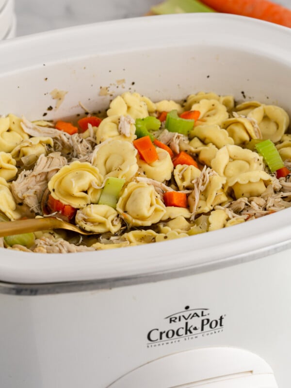 Chicken tortellni soup in a crockpot.