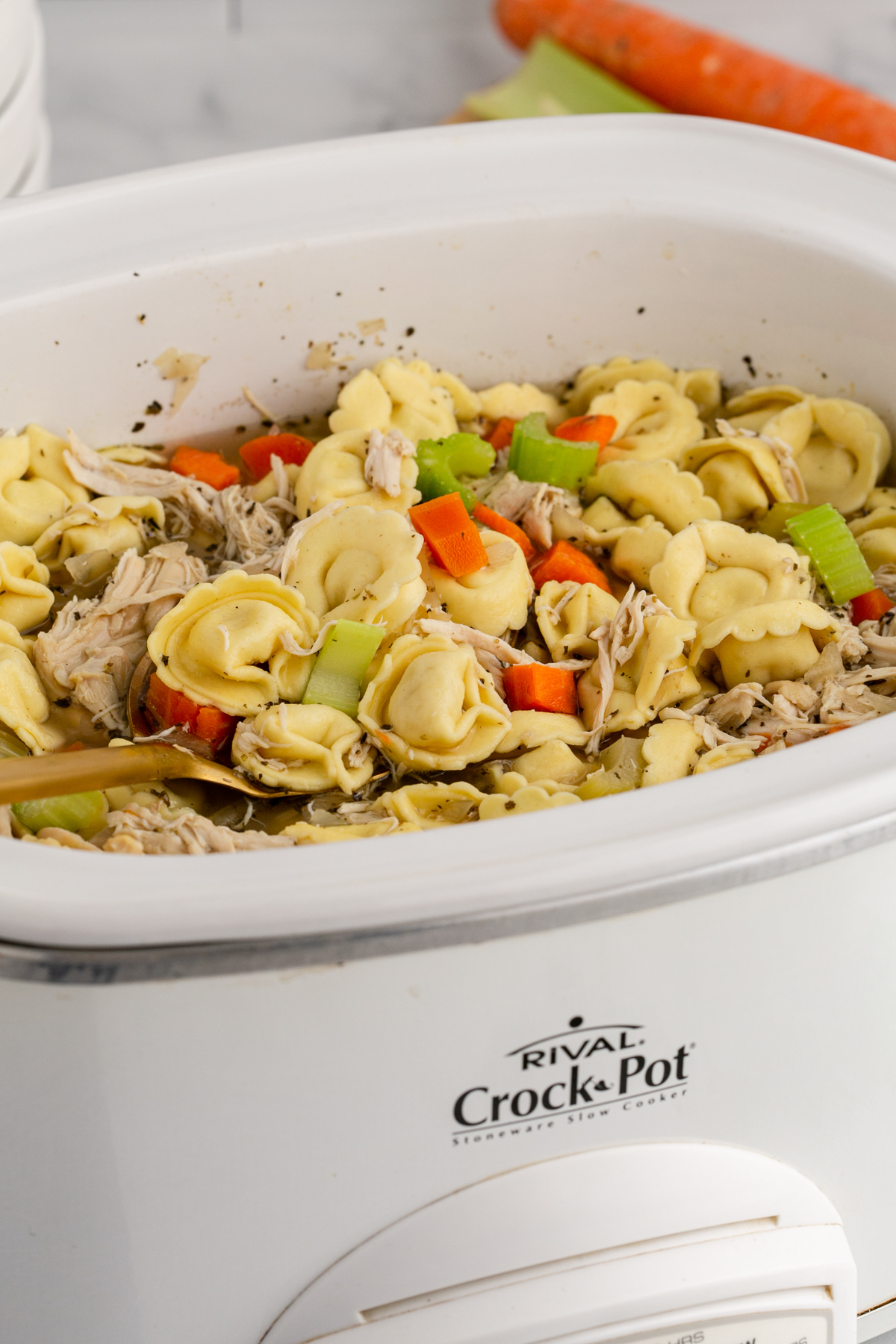 Chicken tortellni soup in a crockpot.