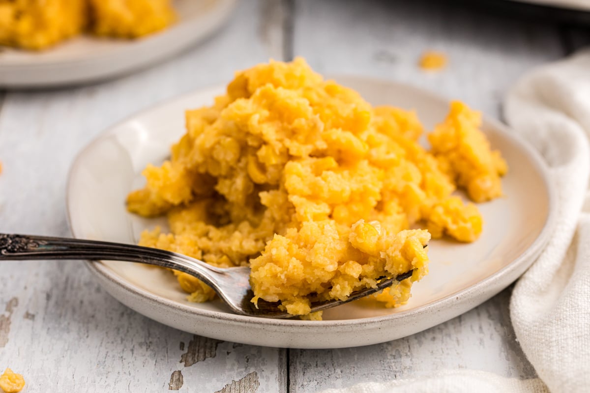 close up of corn casserole with a fork in it.