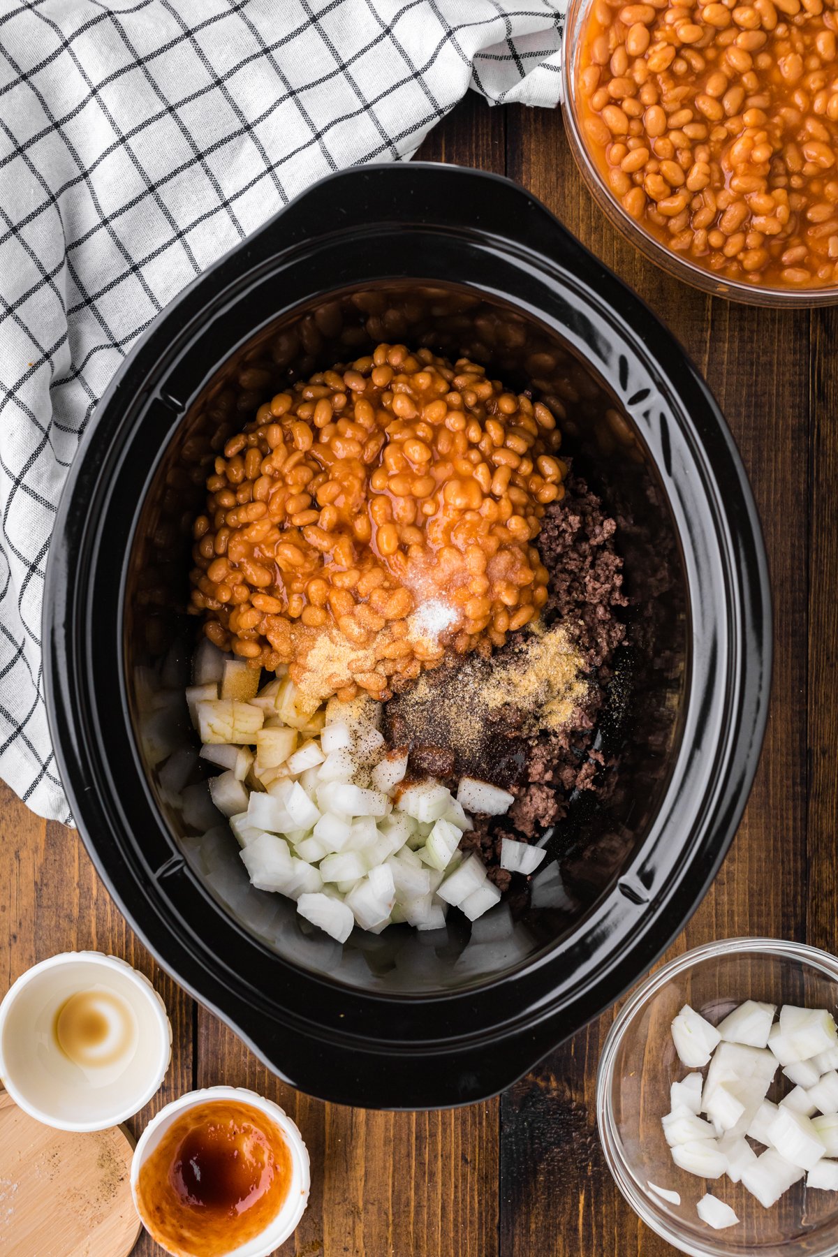 ground beef, baked beans, onions, seasonings and more in a slow cooker to make cowboy beans.