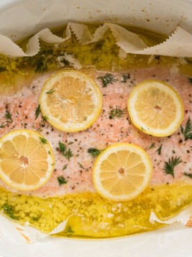 cooked salmon with lemons in a slow cooker.