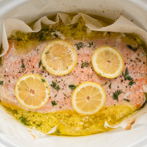 cooked salmon with lemons in a slow cooker.