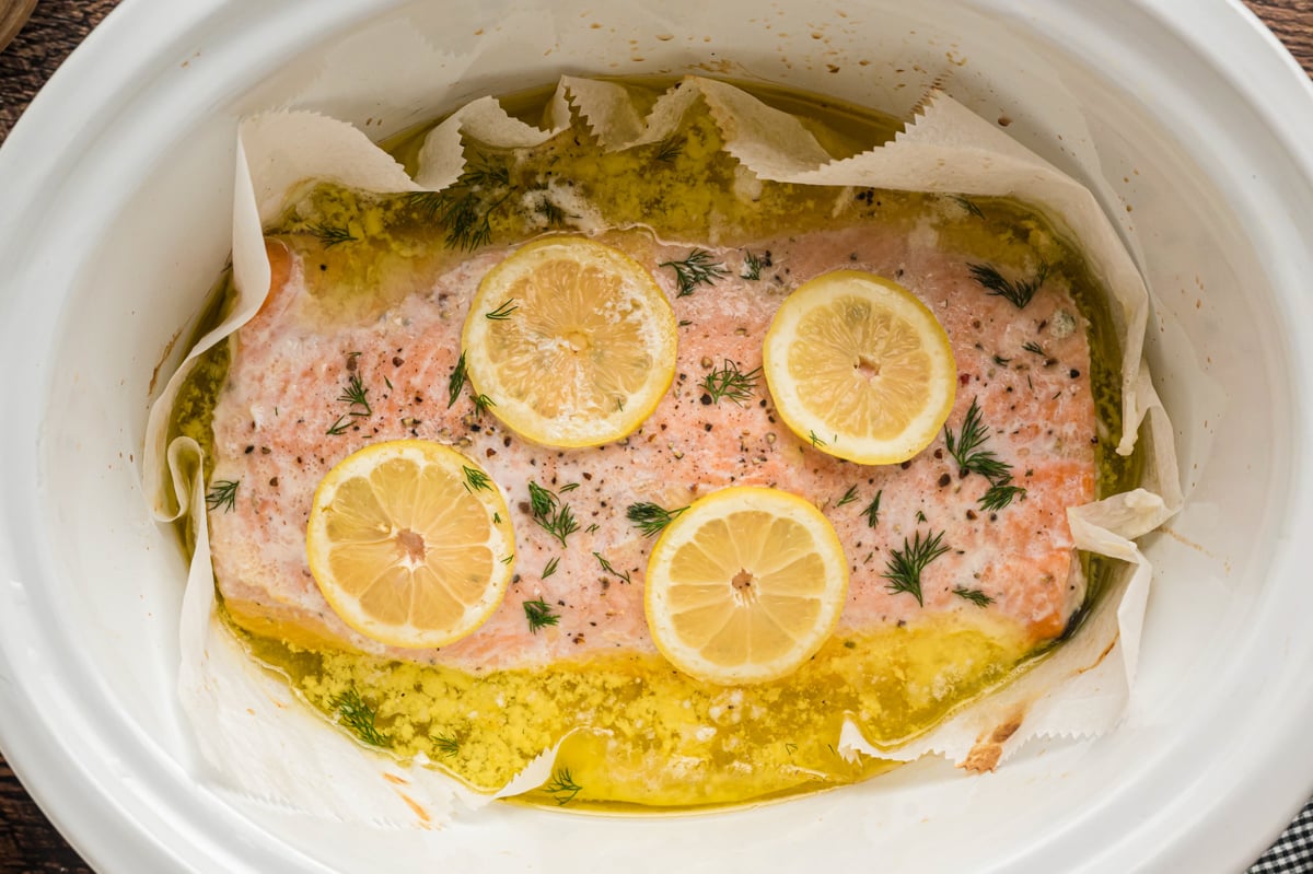 cooked salmon with lemons in a slow cooker.