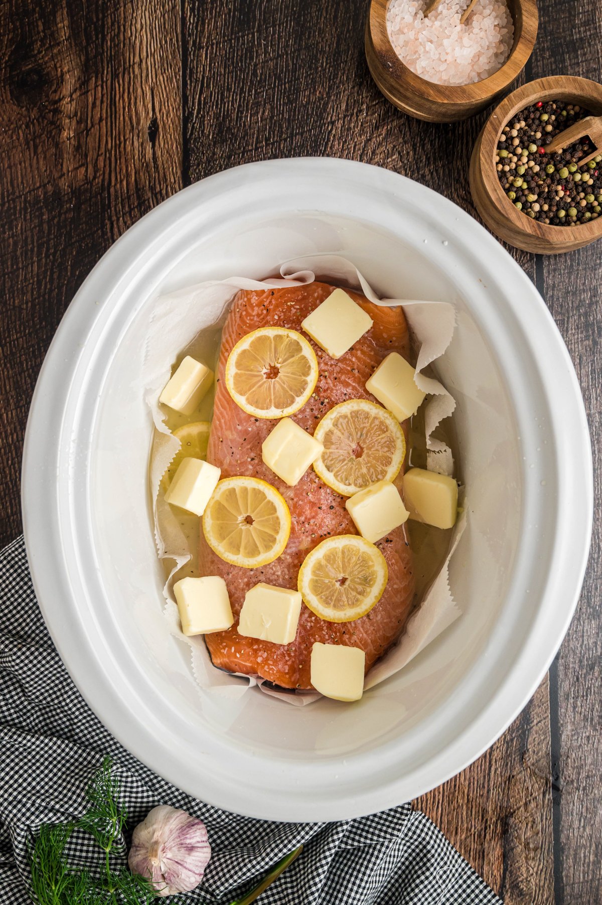lemons and butter on top of the salmon.