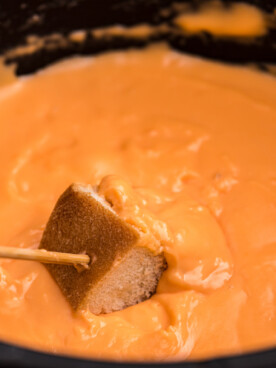 Fondue in a crockpot with bread.