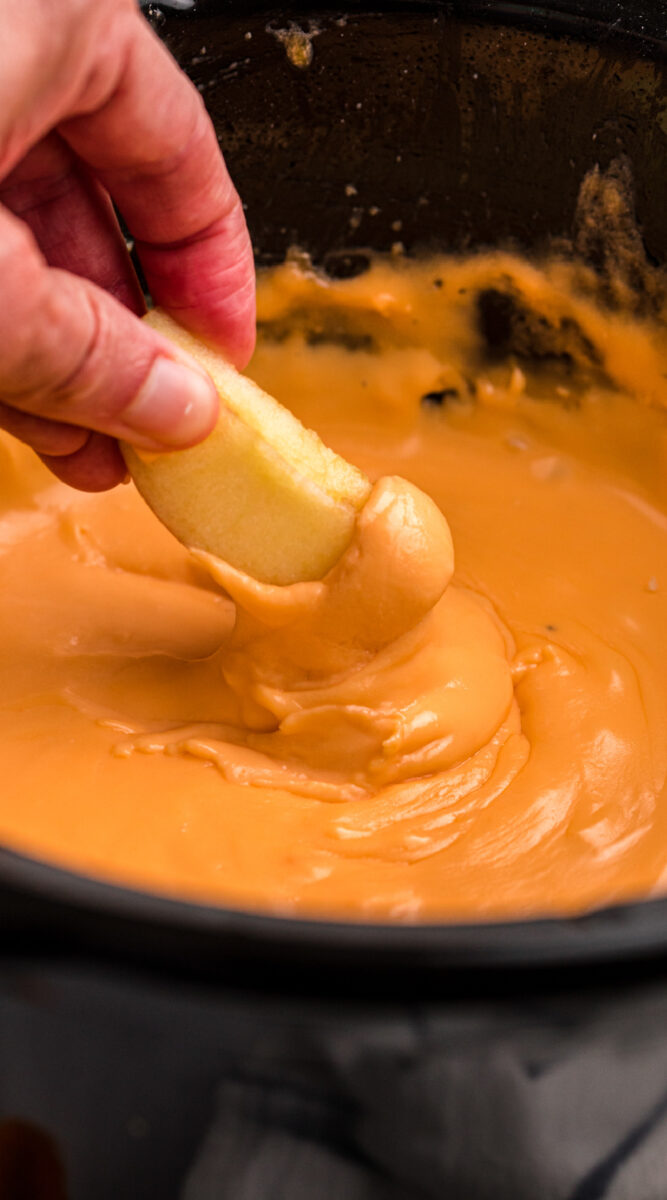 Long image of cheese fondue on an apple for pinterest.