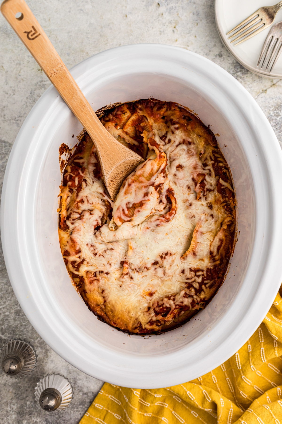 Cooked stuffed shells in a slow cooker.