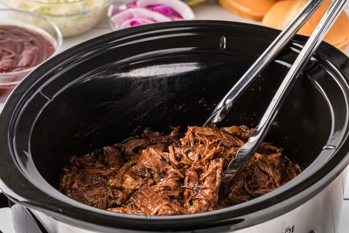 side view of bbq beef in a slow cooker.