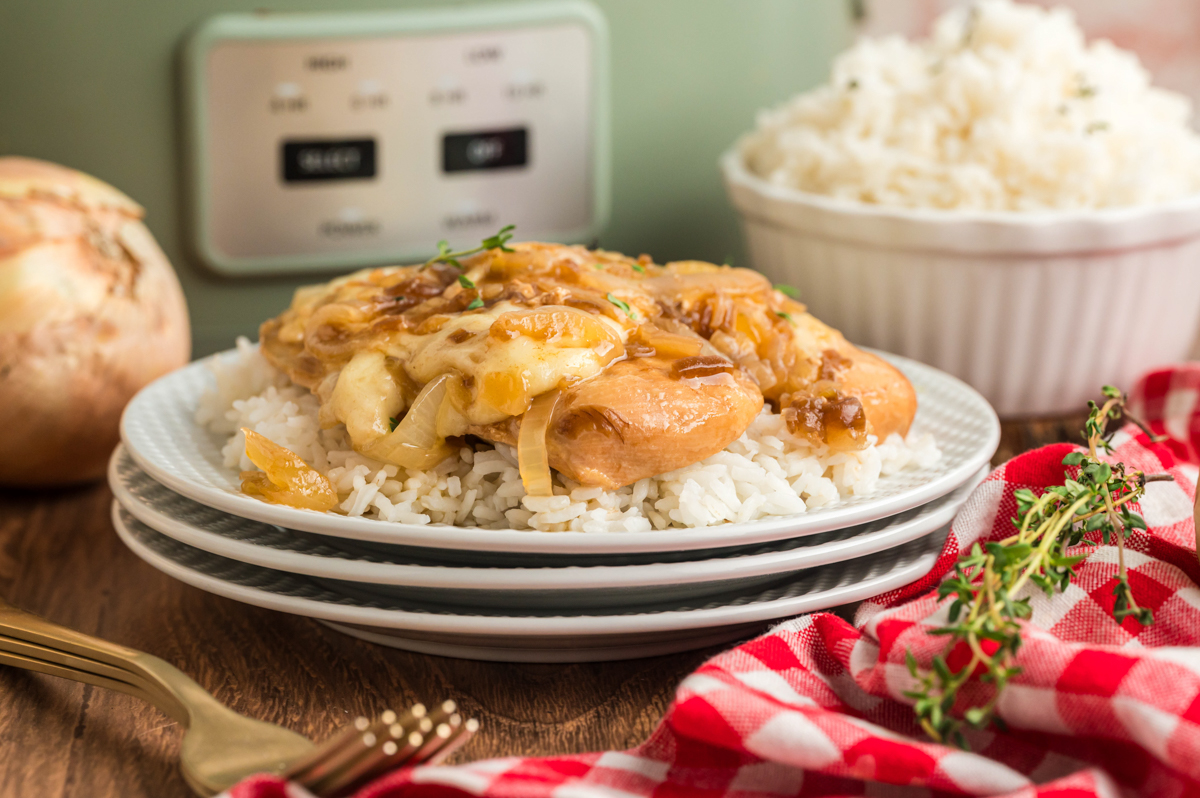 French onion chicken over rice in front of a slow cooker.