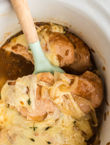 close up of french onion chicken on a spatula.