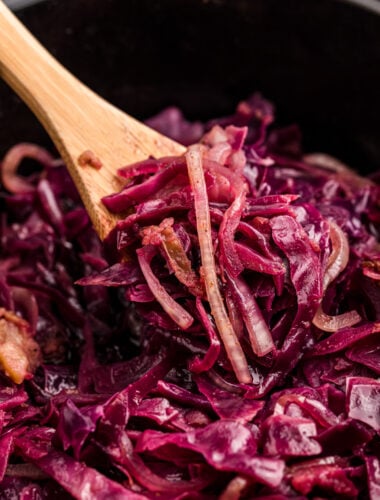 Red cabbage on a wooden spoon in a slow cooker.