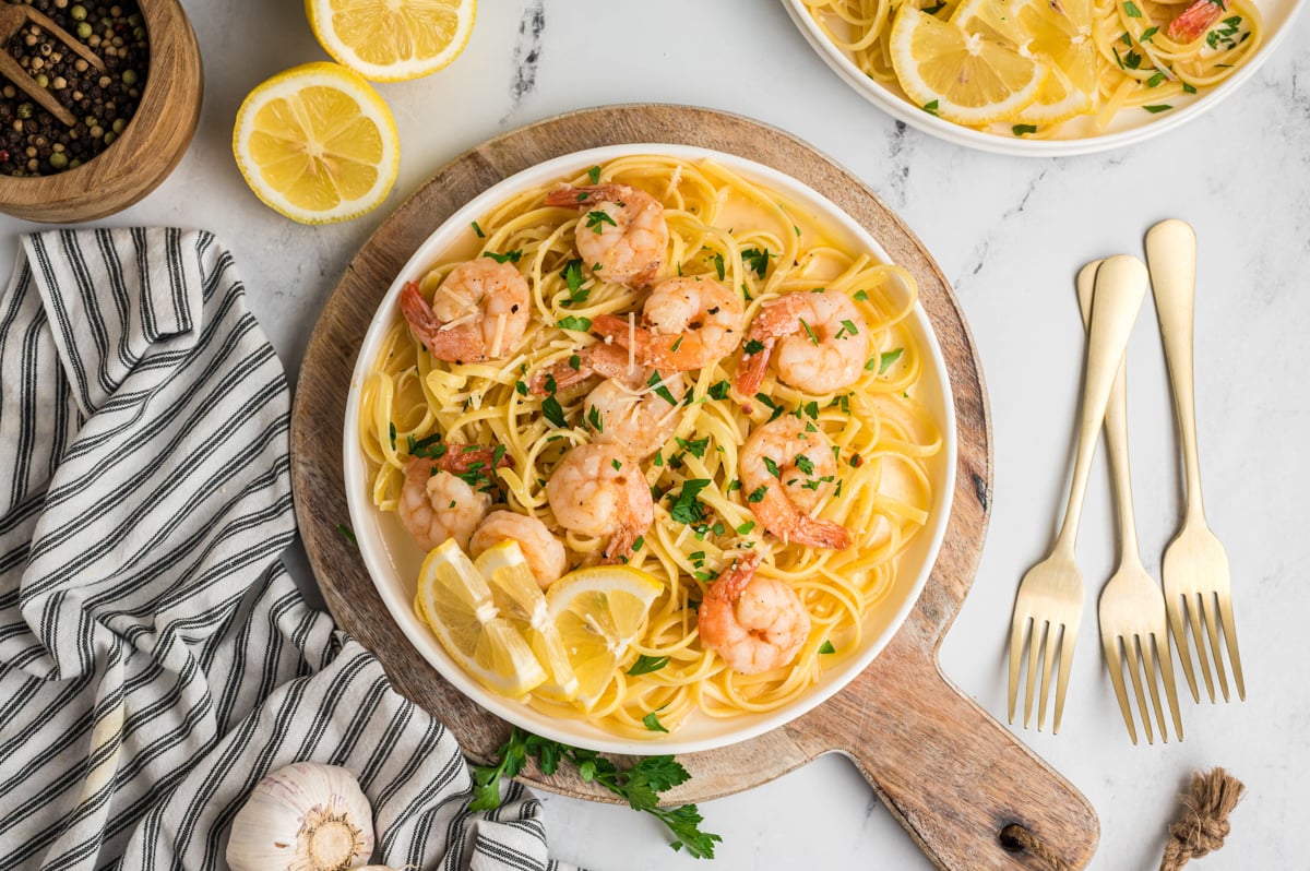 overhead shot of shrimp scampi on a plate with lemons.