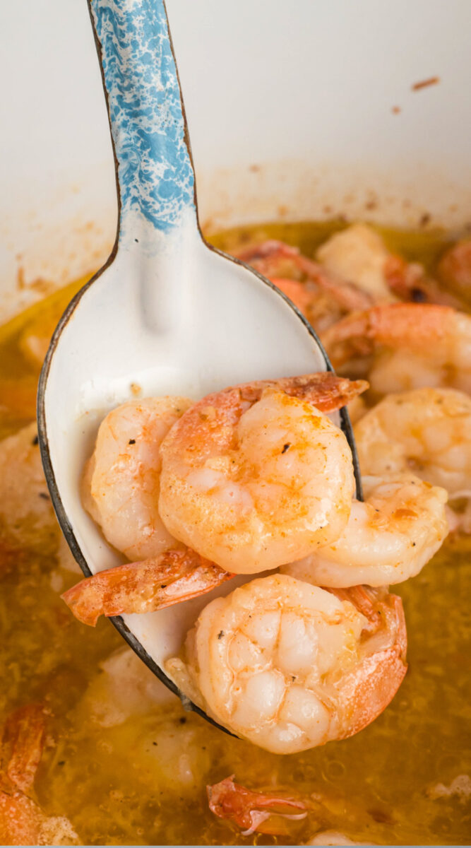 Long image of shrimp scampi on a spoon for pinterest.