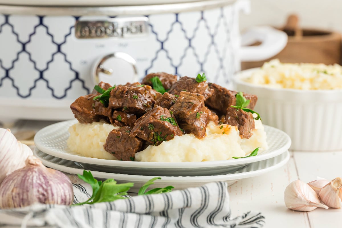 Plate of steak bites on a table.