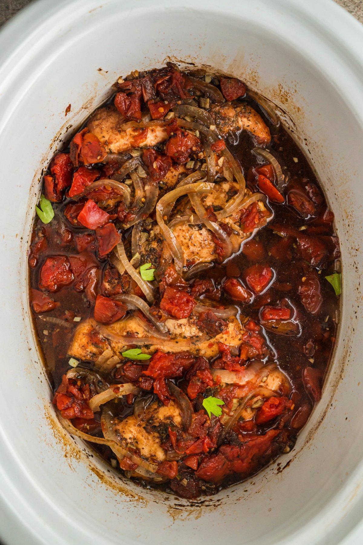 Chicken in slow cooker with balsamic vinegar and tomatoes.