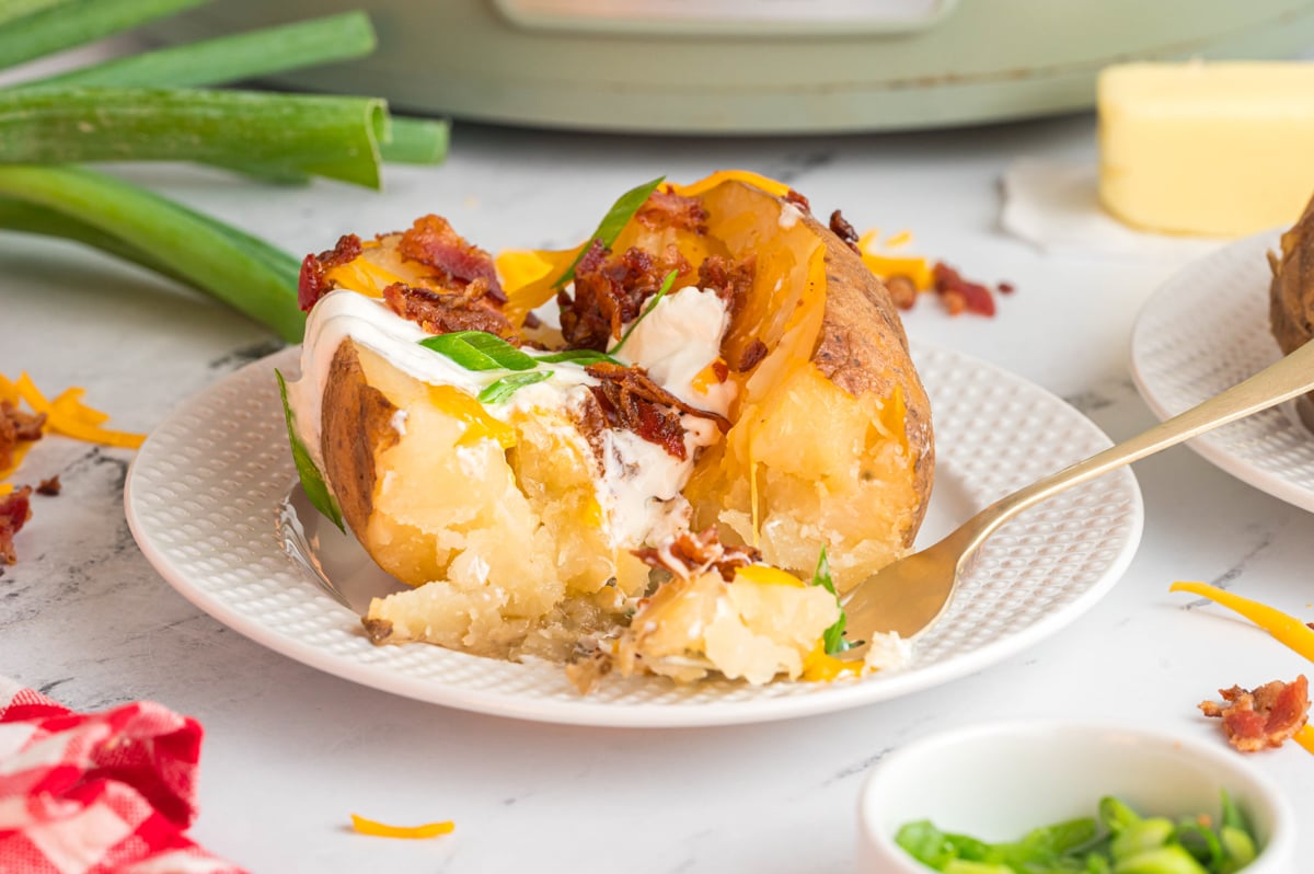 close up of a baked potatoes in a slow cooker.