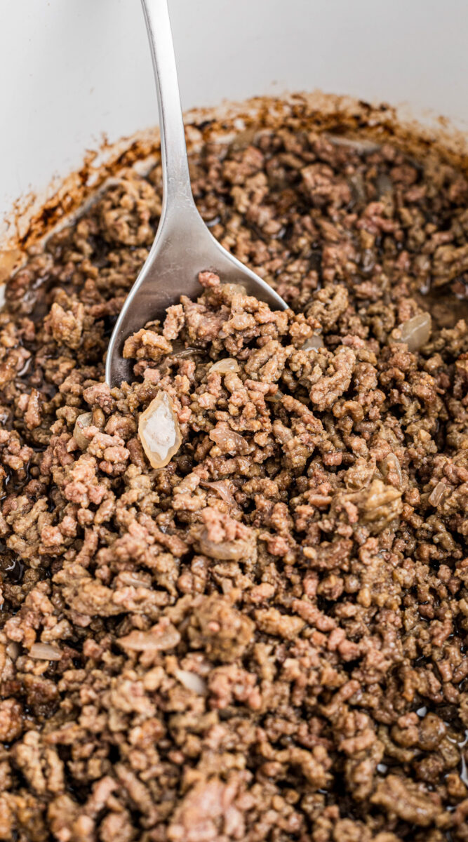 Long image of cooked ground beef with onions.