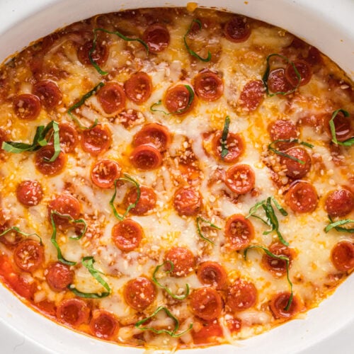 overhead shot of pizza dip in a white slow cooker.
