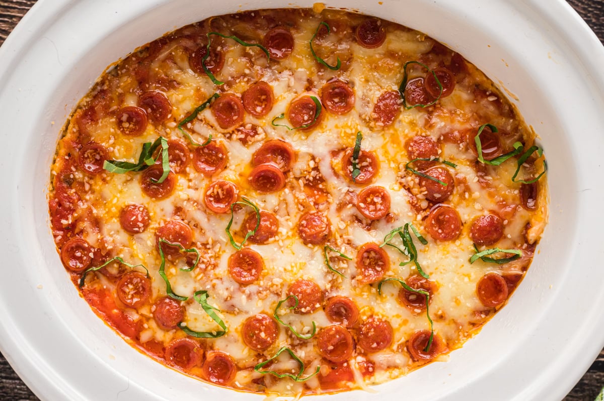 overhead shot of pizza dip in a white slow cooker.