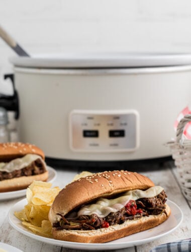 italian beef sandwich in front of a slow cooker.