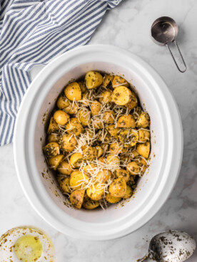 pesto potatoes in a slow cooke with parmesan cheese.