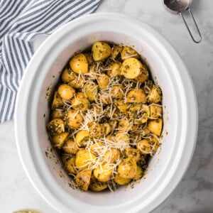pesto potatoes in a slow cooke with parmesan cheese.