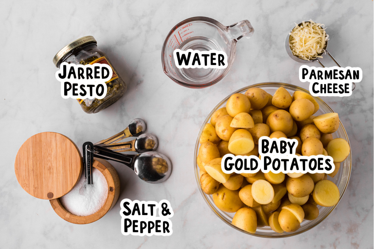 Ingredients for pesto parmesan potatoes on a table.