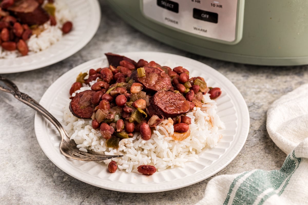 red beans over rice on a plate with a fork.