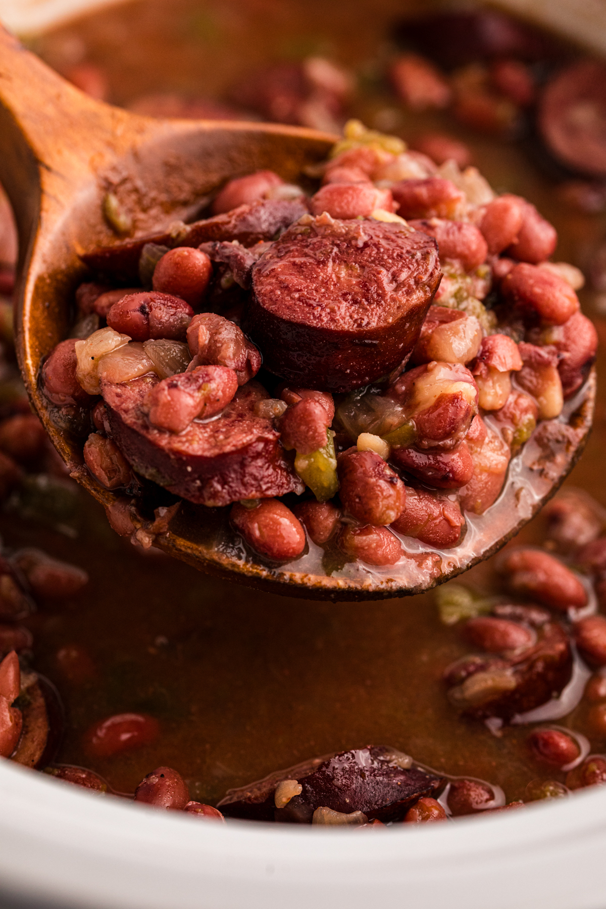 Crockpot red beans on a spoon.