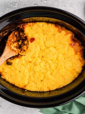 overhead shot of tamale pie with wooden spoon in it.