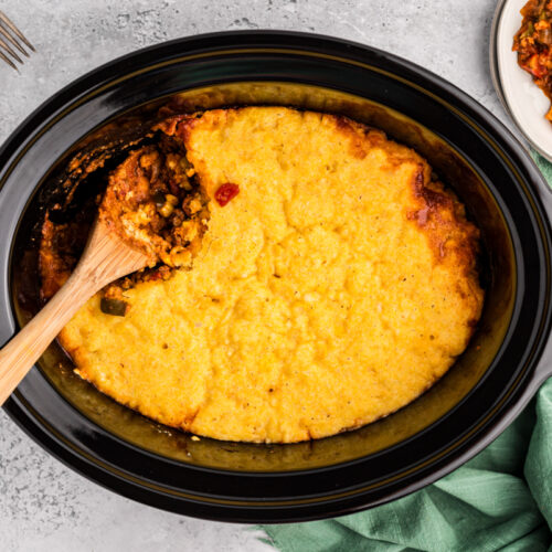 overhead shot of tamale pie with wooden spoon in it.