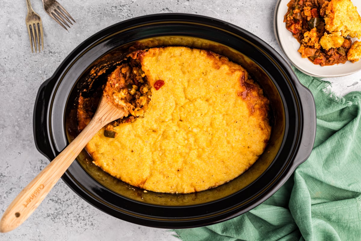 overhead shot of tamale pie with wooden spoon in it.
