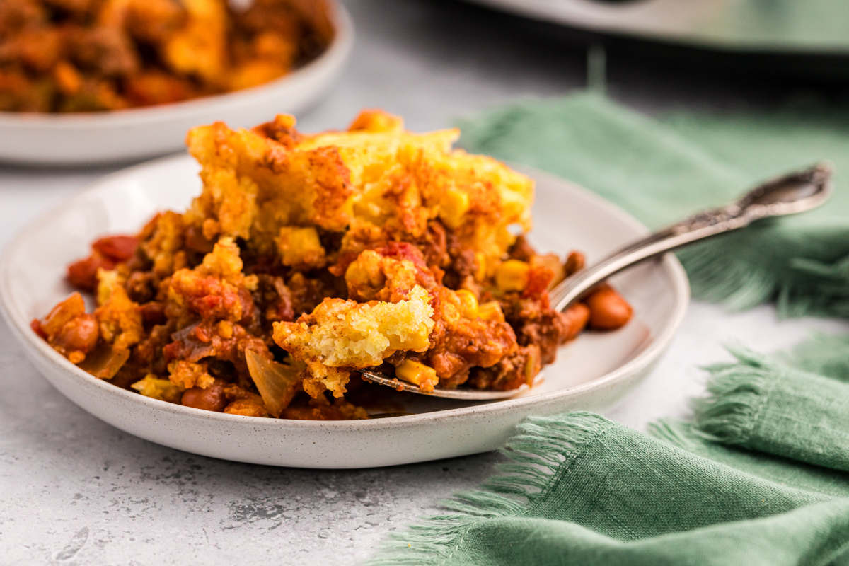 close up of tamale pie on a plate with fork in it.