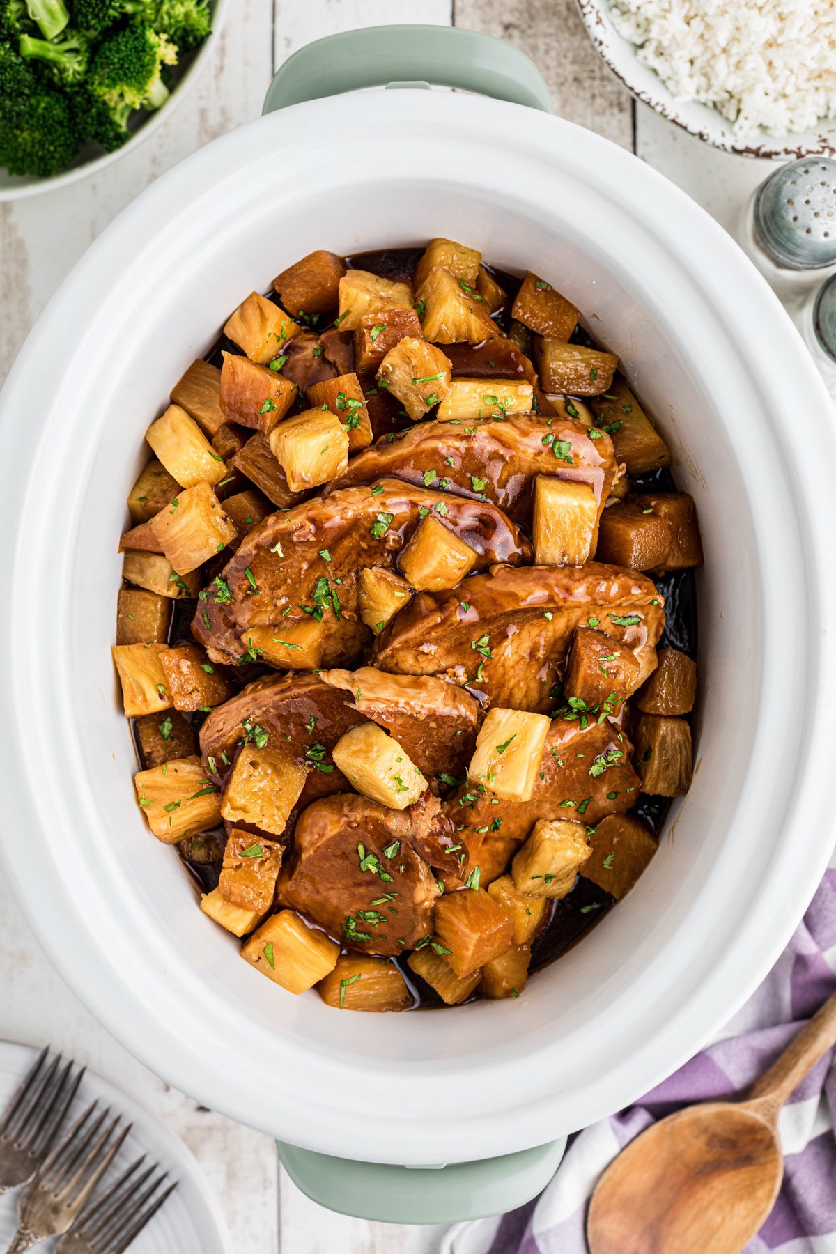 Pork chops in a slow cooker with teriyaki sauce and pineapple.