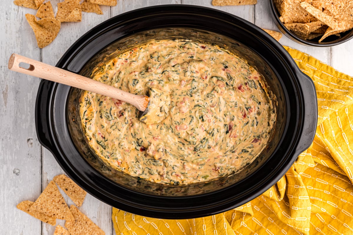 Overhead shot of velveeta spinach with chips on a side.