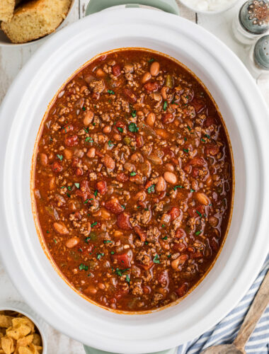 Crockpot full of chili with cornbread on the side.